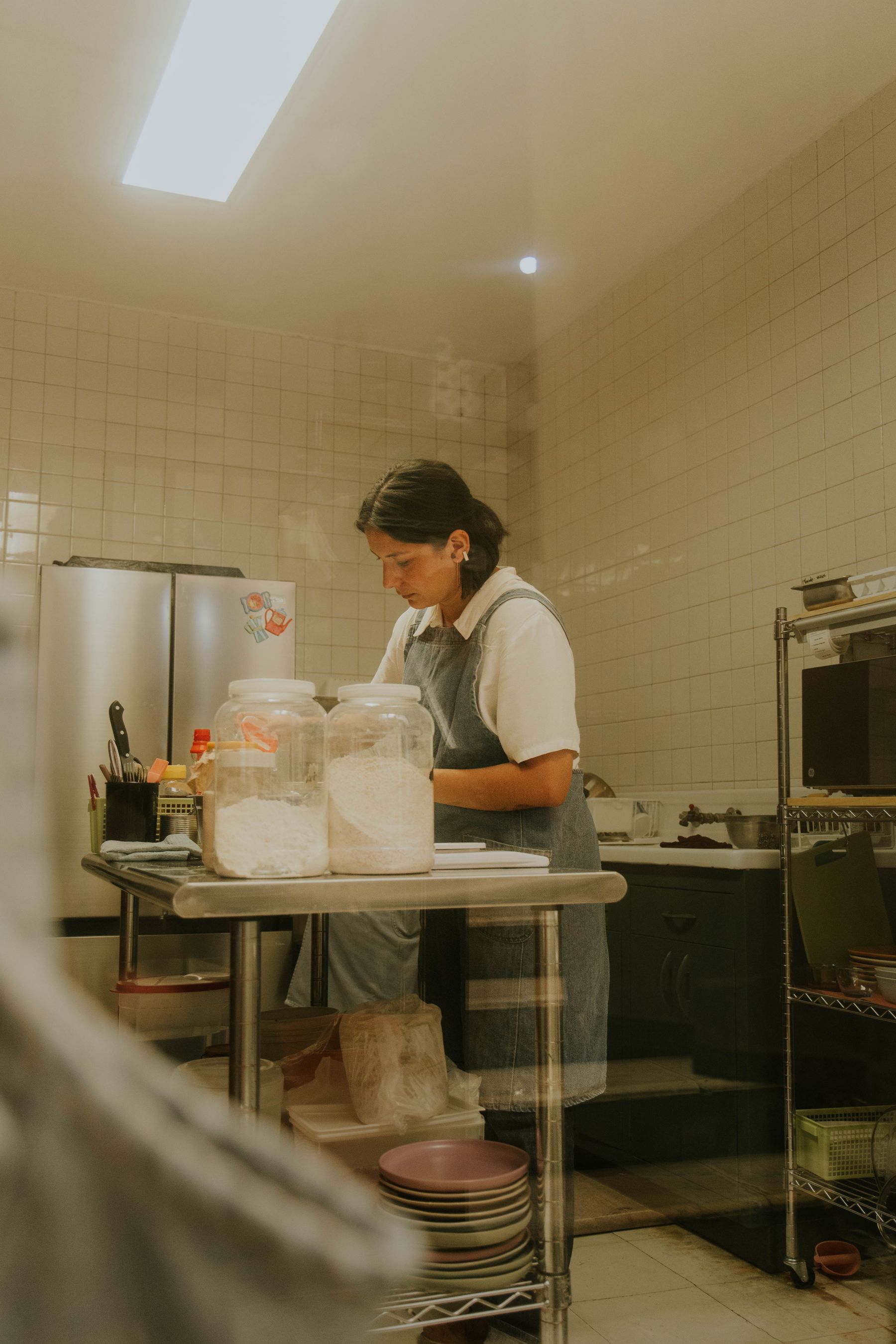 A chef preparing ingredients in a professional stainless-steel kitchen